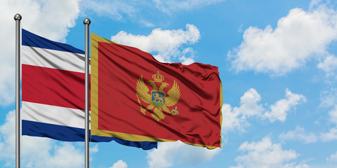 Costa Rica and Montenegro flag waving in the wind against white cloudy blue sky together. Diplomacy concept, international relations.