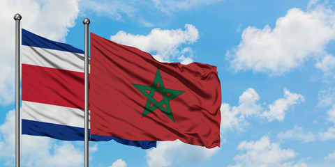 Costa Rica and Morocco flag waving in the wind against white cloudy blue sky together. Diplomacy concept, international relations.