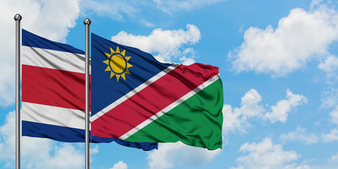 Costa Rica and Namibia flag waving in the wind against white cloudy blue sky together. Diplomacy concept, international relations.