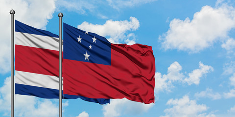 Costa Rica and Samoa flag waving in the wind against white cloudy blue sky together. Diplomacy concept, international relations.