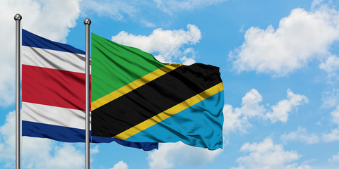 Costa Rica and Tanzania flag waving in the wind against white cloudy blue sky together. Diplomacy concept, international relations.