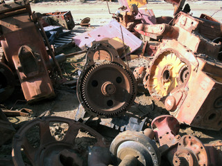 tractor flywheel in pile of parts