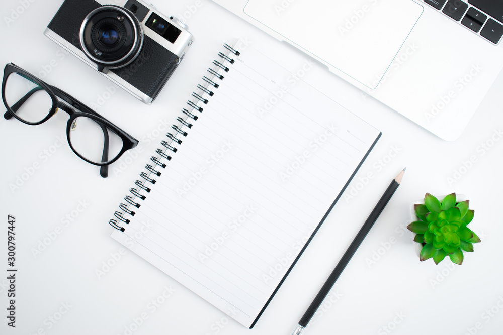 Poster top view with retro cameras, notebooks and keyboards on a white background with copy space.