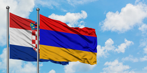 Croatia and Armenia flag waving in the wind against white cloudy blue sky together. Diplomacy concept, international relations.