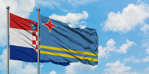 Croatia and Aruba flag waving in the wind against white cloudy blue sky together. Diplomacy concept, international relations.