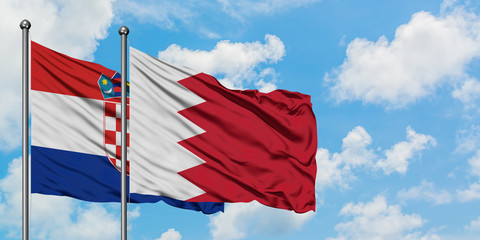 Croatia and Bahrain flag waving in the wind against white cloudy blue sky together. Diplomacy concept, international relations.