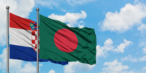 Croatia and Bangladesh flag waving in the wind against white cloudy blue sky together. Diplomacy concept, international relations.