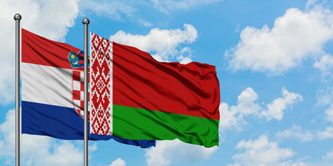 Croatia and Belarus flag waving in the wind against white cloudy blue sky together. Diplomacy concept, international relations.