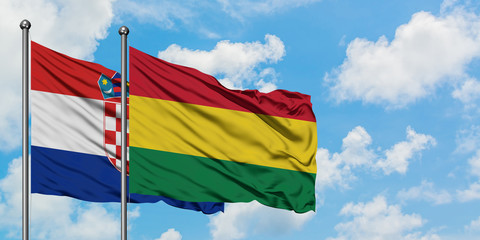 Croatia and Bolivia flag waving in the wind against white cloudy blue sky together. Diplomacy concept, international relations.