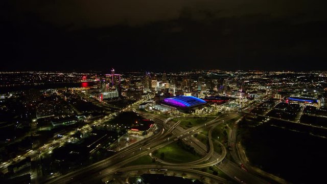 Detroit Michigan Aerial v152 Short and slow nighttime freeway cityscape view while moving in away in reverse - October 2017