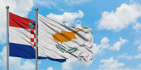 Croatia and Cyprus flag waving in the wind against white cloudy blue sky together. Diplomacy...