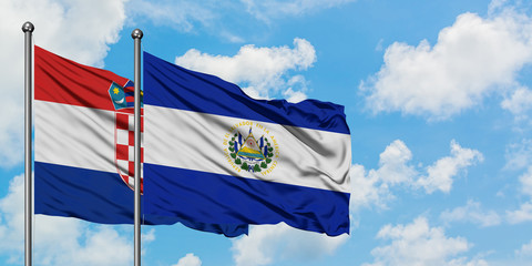 Croatia and El Salvador flag waving in the wind against white cloudy blue sky together. Diplomacy concept, international relations.
