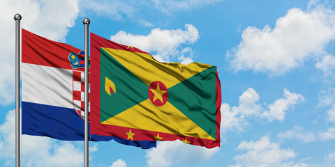 Croatia and Grenada flag waving in the wind against white cloudy blue sky together. Diplomacy concept, international relations.