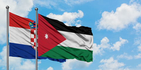 Croatia and Jordan flag waving in the wind against white cloudy blue sky together. Diplomacy concept, international relations.