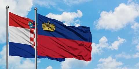 Croatia and Liechtenstein flag waving in the wind against white cloudy blue sky together. Diplomacy concept, international relations.
