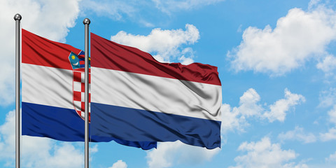 Croatia and Netherlands flag waving in the wind against white cloudy blue sky together. Diplomacy concept, international relations.