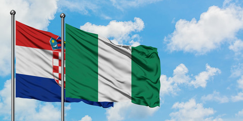 Croatia and Nigeria flag waving in the wind against white cloudy blue sky together. Diplomacy concept, international relations.