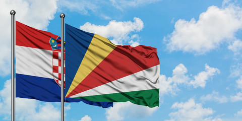 Croatia and Seychelles flag waving in the wind against white cloudy blue sky together. Diplomacy concept, international relations.