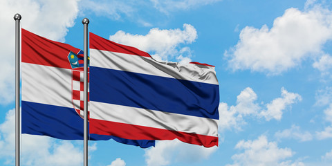 Croatia and Thailand flag waving in the wind against white cloudy blue sky together. Diplomacy concept, international relations.