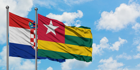 Croatia and Togo flag waving in the wind against white cloudy blue sky together. Diplomacy concept, international relations.
