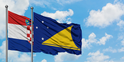 Croatia and Tokelau flag waving in the wind against white cloudy blue sky together. Diplomacy concept, international relations.
