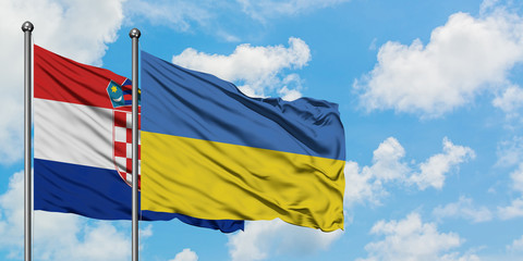 Croatia and Ukraine flag waving in the wind against white cloudy blue sky together. Diplomacy concept, international relations.