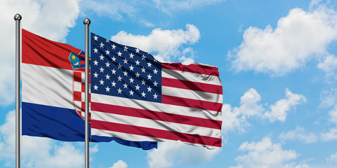 Croatia and United States flag waving in the wind against white cloudy blue sky together. Diplomacy concept, international relations.