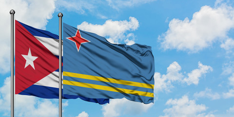 Cuba and Aruba flag waving in the wind against white cloudy blue sky together. Diplomacy concept, international relations.