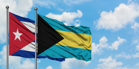 Cuba and Bahamas flag waving in the wind against white cloudy blue sky together. Diplomacy concept, international relations.