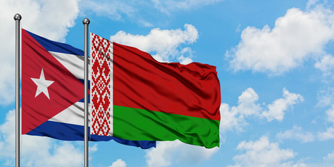 Cuba and Belarus flag waving in the wind against white cloudy blue sky together. Diplomacy concept, international relations.