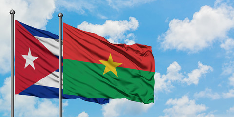 Cuba and Burkina Faso flag waving in the wind against white cloudy blue sky together. Diplomacy concept, international relations.