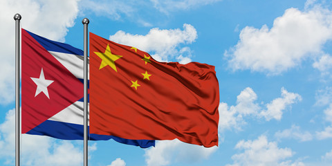 Cuba and China flag waving in the wind against white cloudy blue sky together. Diplomacy concept, international relations.