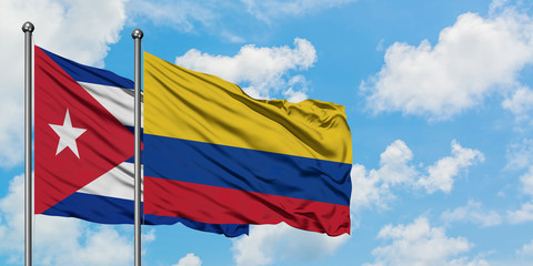 Cuba and Colombia flag waving in the wind against white cloudy blue sky together. Diplomacy concept, international relations.