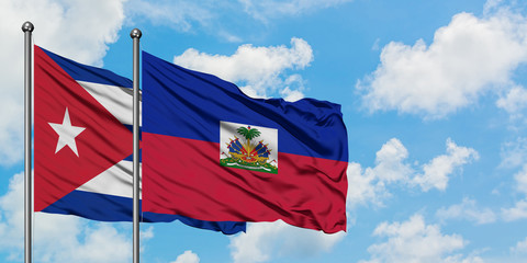 Cuba and Haiti flag waving in the wind against white cloudy blue sky together. Diplomacy concept, international relations.