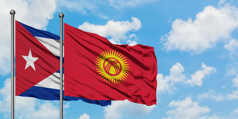 Cuba and Kyrgyzstan flag waving in the wind against white cloudy blue sky together. Diplomacy concept, international relations.