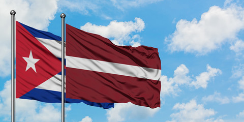 Cuba and Latvia flag waving in the wind against white cloudy blue sky together. Diplomacy concept, international relations.