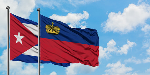 Cuba and Liechtenstein flag waving in the wind against white cloudy blue sky together. Diplomacy concept, international relations.