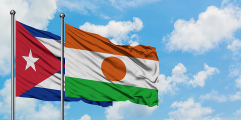 Cuba and Niger flag waving in the wind against white cloudy blue sky together. Diplomacy concept, international relations.