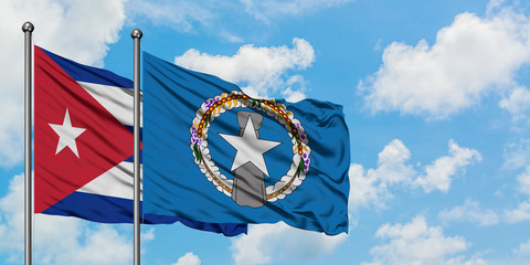Cuba and Northern Mariana Islands flag waving in the wind against white cloudy blue sky together....