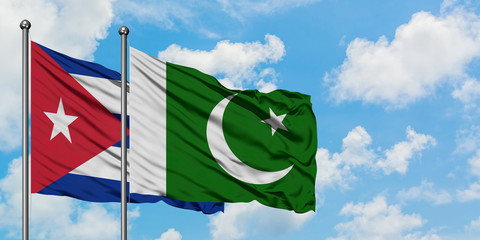 Cuba and Pakistan flag waving in the wind against white cloudy blue sky together. Diplomacy concept, international relations.