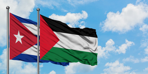 Cuba and Palestine flag waving in the wind against white cloudy blue sky together. Diplomacy concept, international relations.