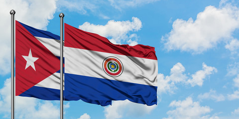 Cuba and Paraguay flag waving in the wind against white cloudy blue sky together. Diplomacy concept, international relations.