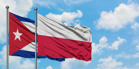 Cuba and Poland flag waving in the wind against white cloudy blue sky together. Diplomacy concept, international relations.
