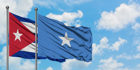 Fototapeta premium Cuba and Somalia flag waving in the wind against white cloudy blue sky together. Diplomacy concept, international relations.