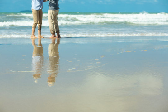 Family, Age, Travel, Tourism And People Concept - Reflex Beach Senior Couple Holding Hands And Dancing On Summer Beach