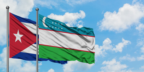 Cuba and Uzbekistan flag waving in the wind against white cloudy blue sky together. Diplomacy concept, international relations.