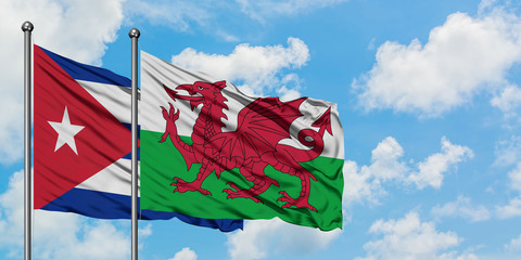 Cuba and Wales flag waving in the wind against white cloudy blue sky together. Diplomacy concept, international relations.