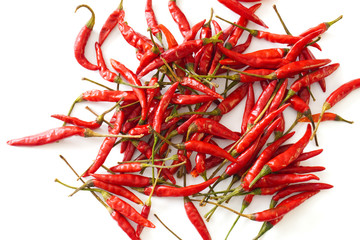 Fototapeta premium Close-up of bright red Thai bird chiles isolated on a white background