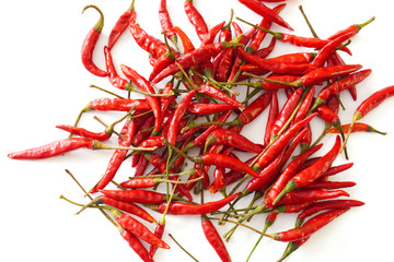 Close-up of bright red Thai bird chiles isolated on a white background