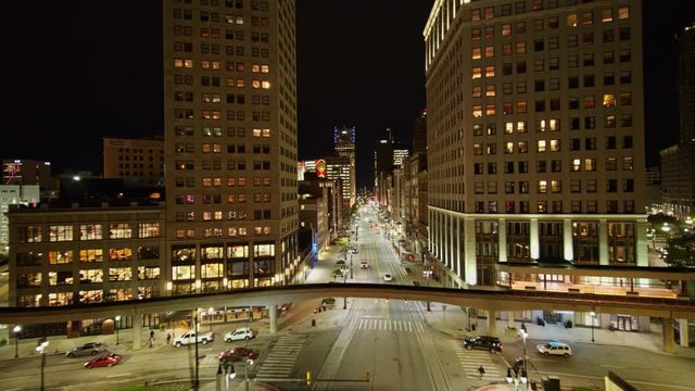 Detroit Michigan Aerial v157 Low nighttime fly over cityscape of Woodward Avenue vantage to high, near vertical downtown and river views - October 2017
